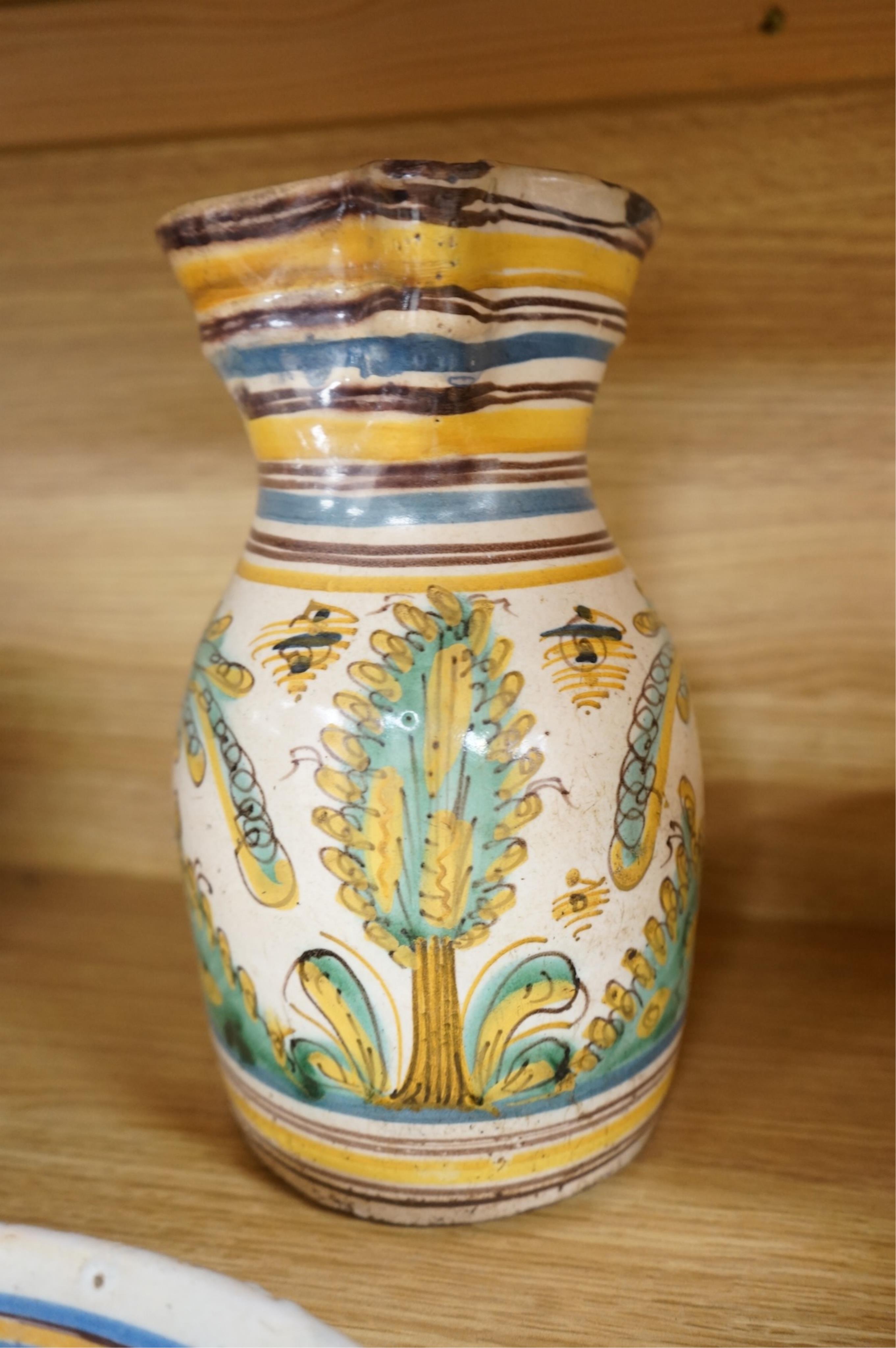 A late 17th century Spanish tin glazed jug together with Moroccan and pottery bowls and dishes (5). Jug 26cm high.